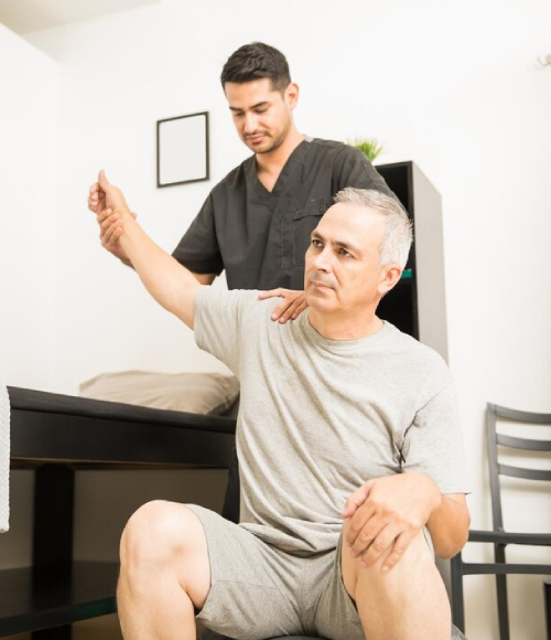 NDIS physiotherapy session helping senior patient with shoulder rehabilitation.