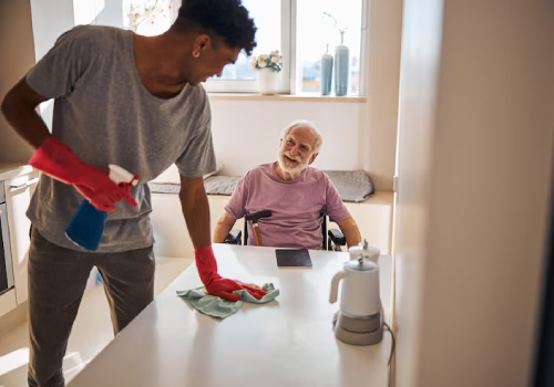 NDIS Household Task Support helping elderly client with home cleaning.